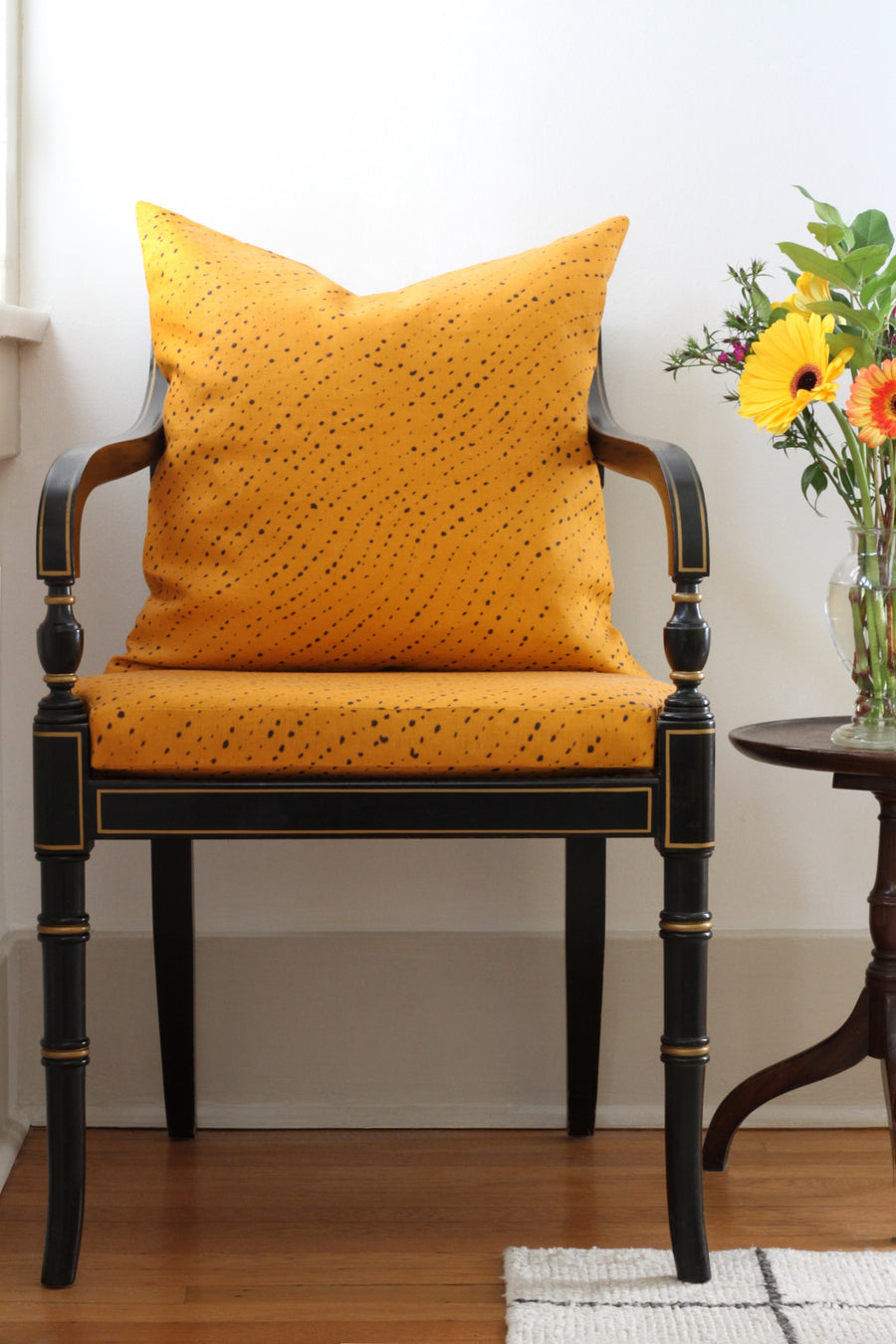 marigold yellow staccato nero shibori upholstery and pillow on a regency chair in fine linen fabric by the yard printed to order in the usa