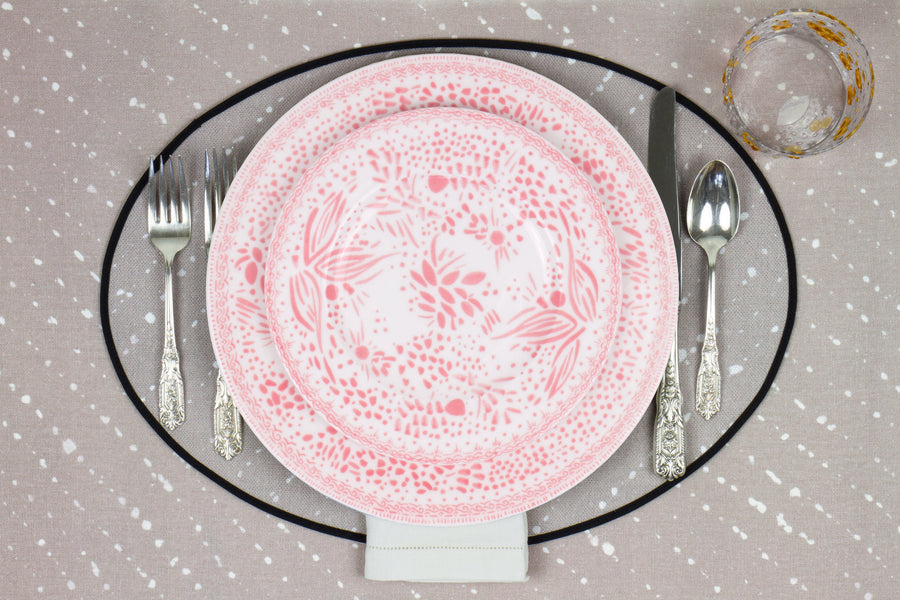 Venable Moore Mosaic Garden stacked dinner and salad/dessert plate in grapefruit pink with hand-painted Bubble glass on neutral flax tan 'Staccato Sbiancato' Shibori linen placemat and tablecloth with silverware and white linen napkin