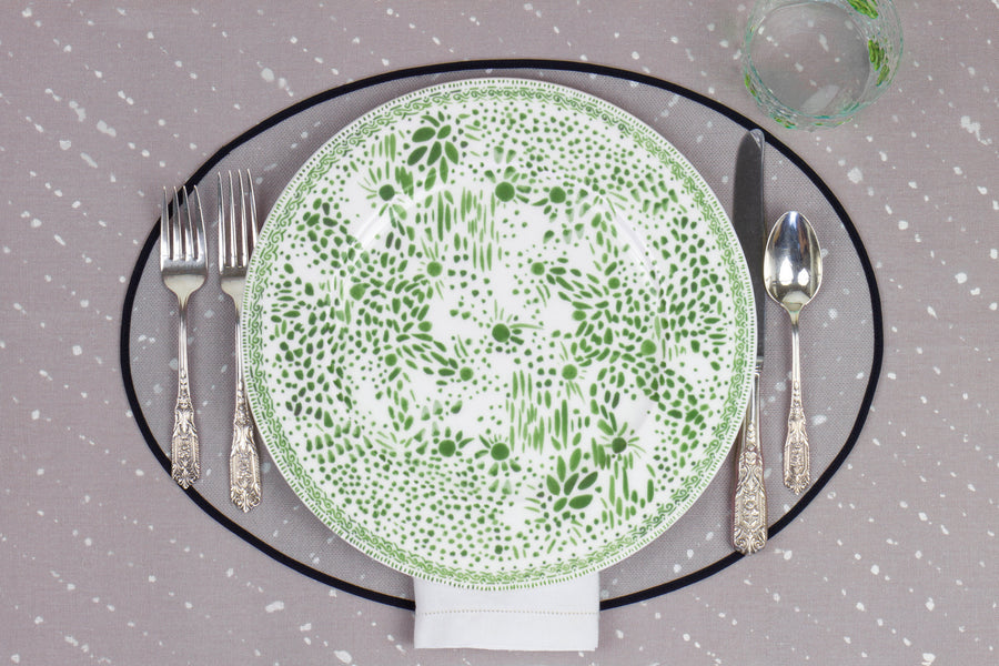 Venable Moore Mosaic Garden dinner plate in grass green with hand-painted Bubble glass on neutral flax tan 'Staccato Sbiancato' Shibori linen placemat and tablecloth with silverware and white linen napkin