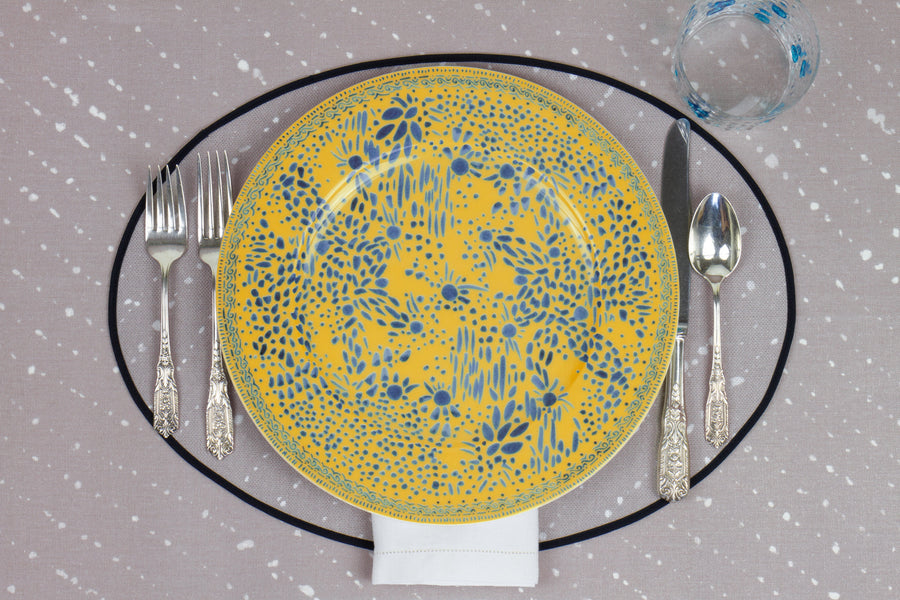 Venable Moore Mosaic Garden dinner plate in fresh lemon yellow with hand-painted Bubble glass on neutral flax tan 'Staccato Sbiancato' Shibori linen placemat and tablecloth with silverware and white linen napkin