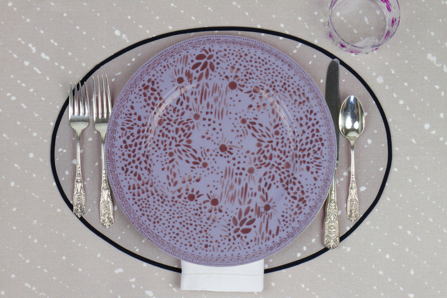 Venable Moore Mosaic Garden dinner plate in soft myrtle purple with hand-painted Bubble glass on neutral flax tan 'Staccato Sbiancato' Shibori linen placemat and tablecloth with silverware and white linen napkin