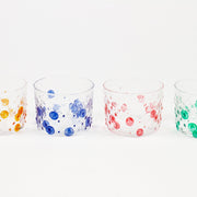 Set of four hand-painted hobnail glasses in tangerine orange, lapis blue, tomato red, and green shamrock