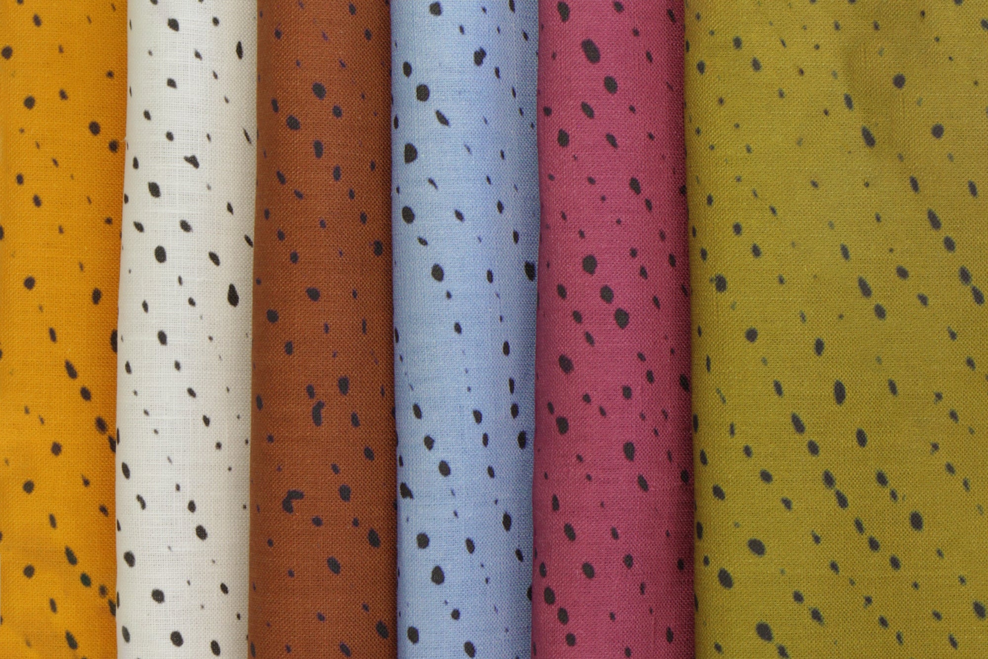 Staccato Nero Shibori linen in marigold, alabaster, russet, cerise, and moss