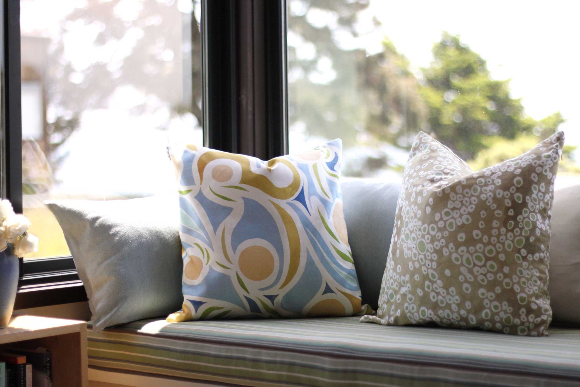 Venable Moore Capri floral linen pillow in peach with Frizzante dotted linen pillow in buff on window seat