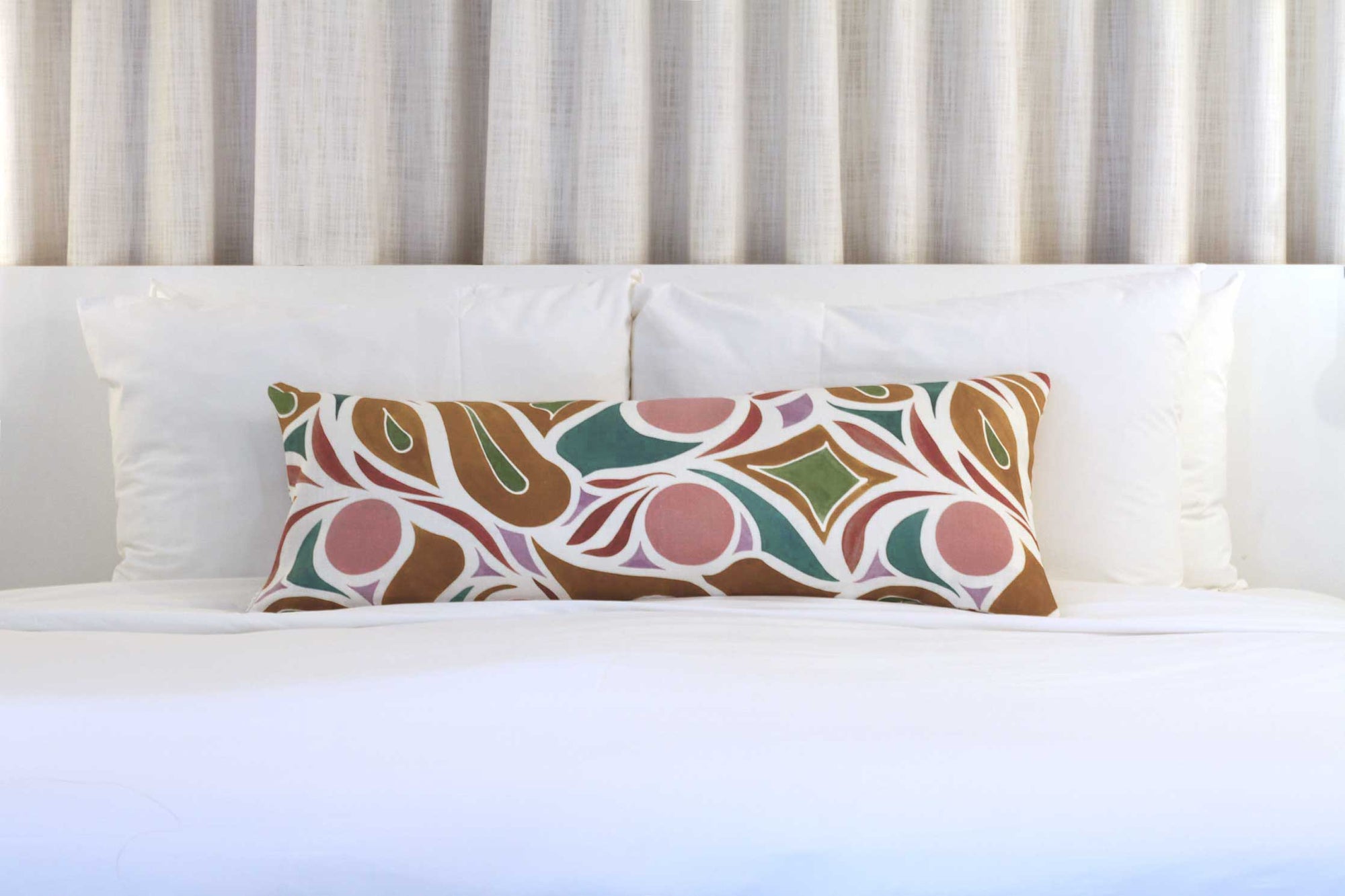 Venable Moore Capri floral linen in pillow in damson plum on white bed with curtain