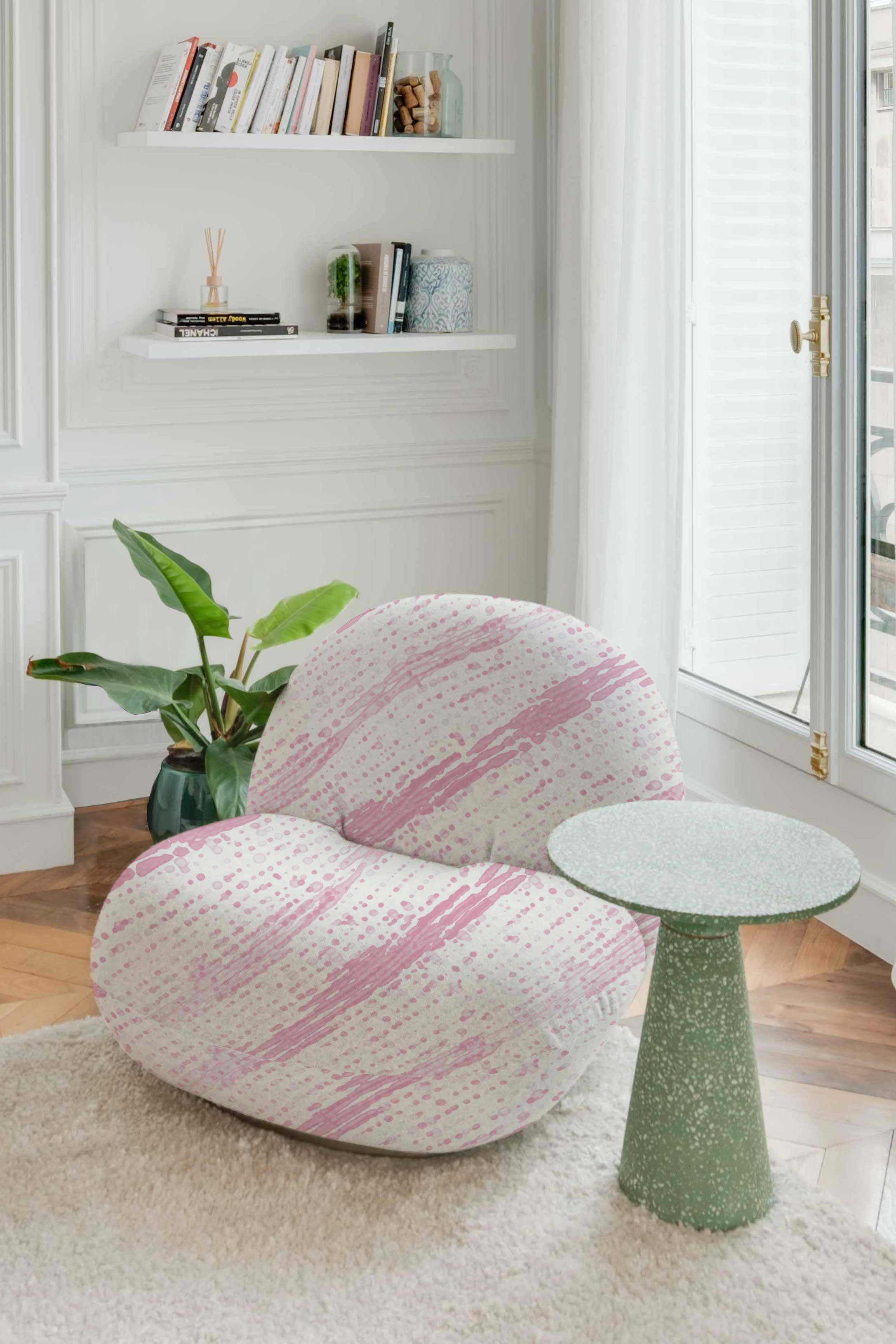 Venable Moore Glissando Shibori linen in Posy Pink on modern chair by green table in bright Parisian apartment