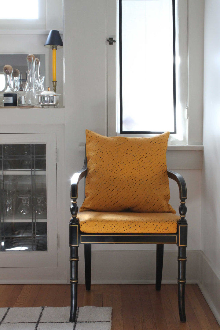 Venable Moore Staccato Nero Shibori linen in Marigold yellow on regency chair in front of window