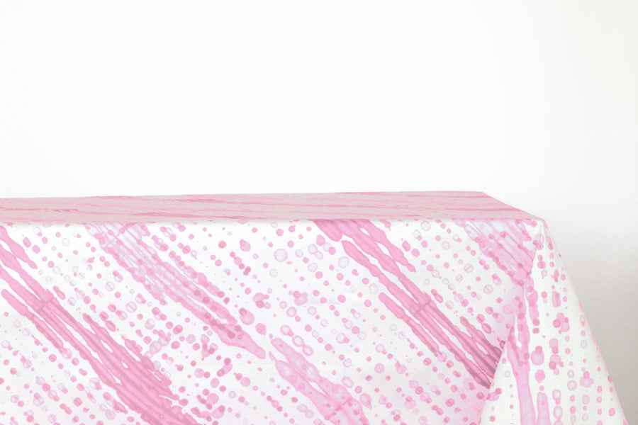 Glissando sbiancato shibori 100% cotton tablecloth in delicate posy pink on table against a white background 