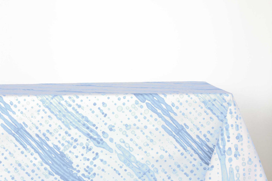 Glissando sbiancato shibori 100% cotton tablecloth in soft powder blue on table against a white background 