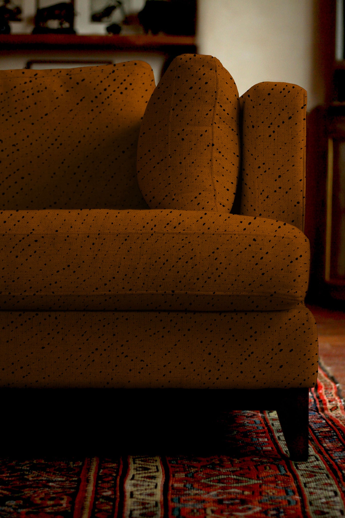 Sofa covered in Venable Moore Staccato Nero Shibori Linen in Russet in living room with oriental rug 