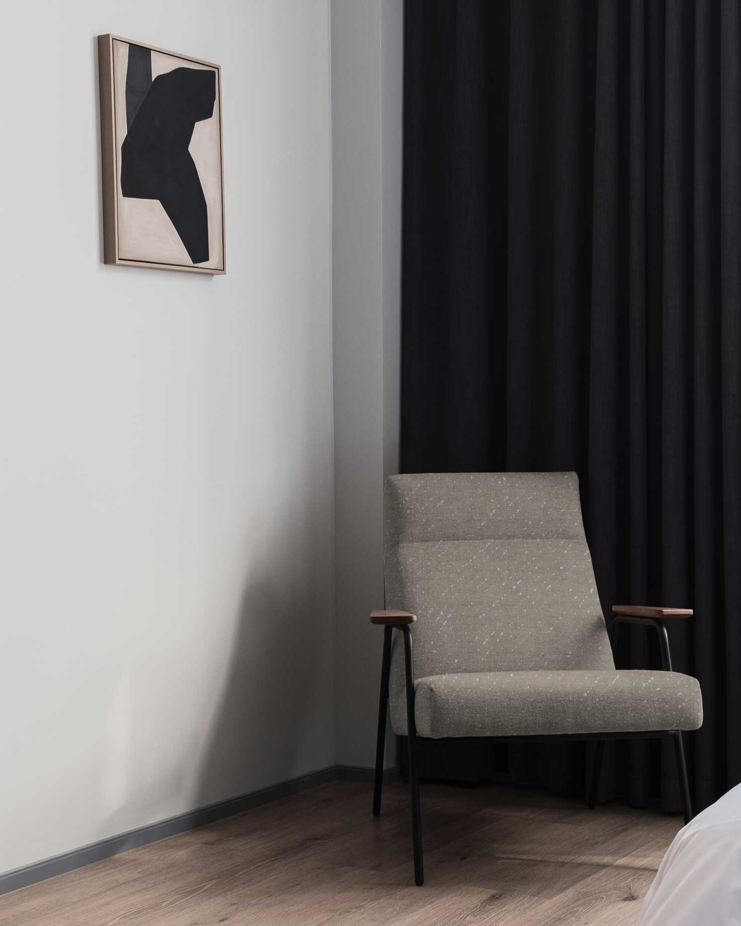 Venable Moore made to order Staccato Sbiancato linen in Flax neutral on armchair in contemporary black and white bedroom with graphic art adn black curtains