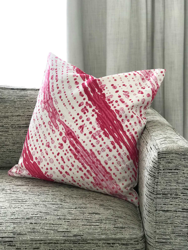 Venable Moore made to order Glissando Shibori linen pillow in Strawberry pink on sofa in front of window with curtain