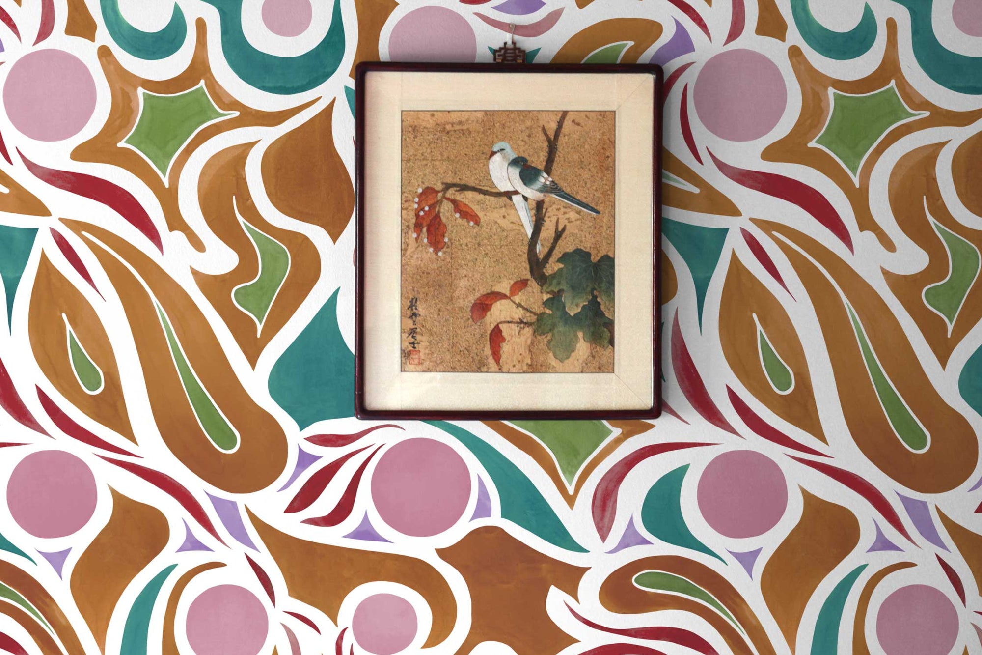 Capri floral wallpaper in damson by Venable Moore installed with a framed picture of two birds