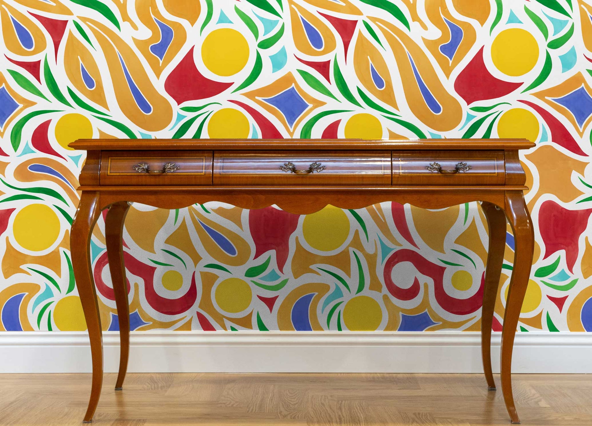 Venable Moore Capri floral wallpaper in lemon installed in a room with a wooden desk