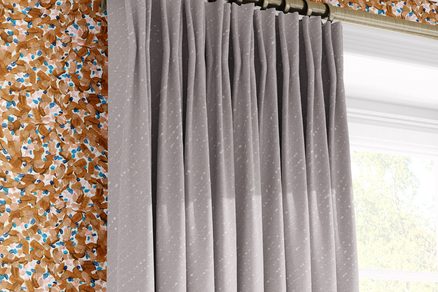 Venable Moore Chintz Modern floral abstract in apricot orange, peach, and blue made-to-order, printed in the U.S.A. wallpaper on a wall with 100% European linen “Staccato Sbiancato’’ Shibori curtains in natural flax and window 
