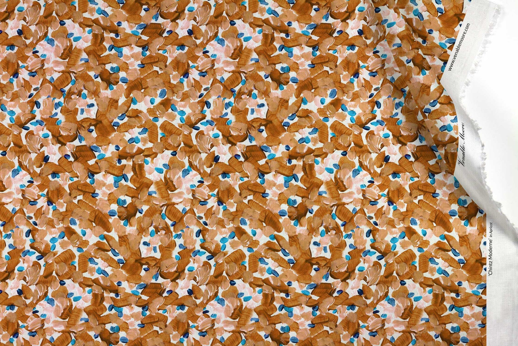 Venable Moore 100% Cotton Chintz Moderne abstract floral fabric by the yard in apricot orange, blue, and white with top fold against white
