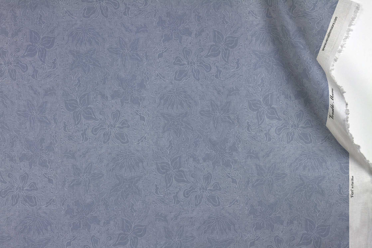 Venable Moore 100% Cotton Fiori hand drawn floral fabric by the yard in flat blue with top fold against white