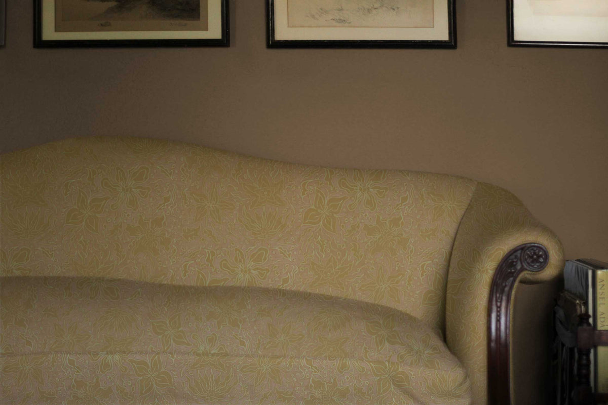 Fiori hand drawn floral in cotton fabric upholstered in yellow sulphur on a sofa installed in a living room