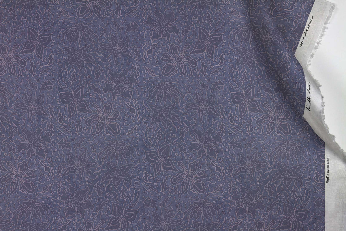 Venable Moore 100% Cotton Fiori hand drawn floral fabric by the yard in washed denim blue with top fold against white