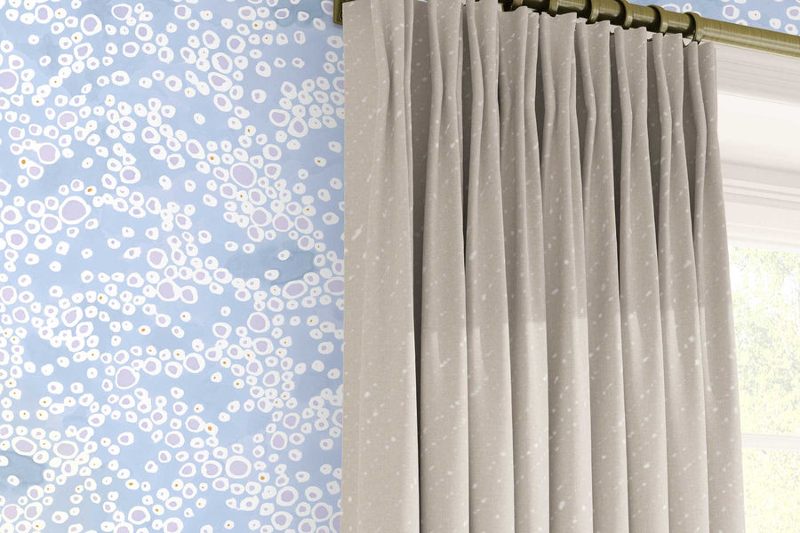 Venable Moore ‘‘Frizzante’ Pastel Ice blue made-to-order, printed in the U.S.A. wallpaper on a wall with 100% European linen “Staccato Sbiancato’ Shibori curtains in flax natural and window 