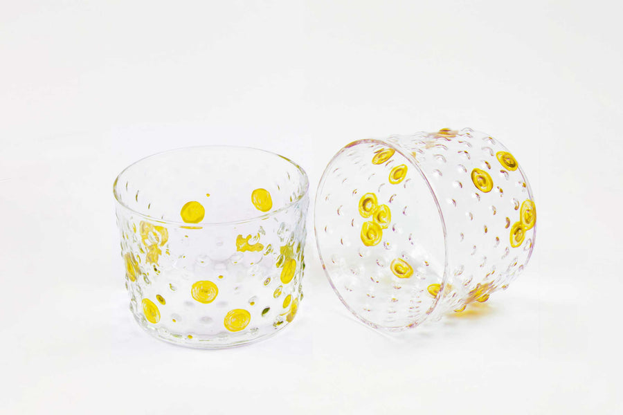 venable moore sun yellow hand-painted hand-blown bubble glasses set of two on white background one on its side