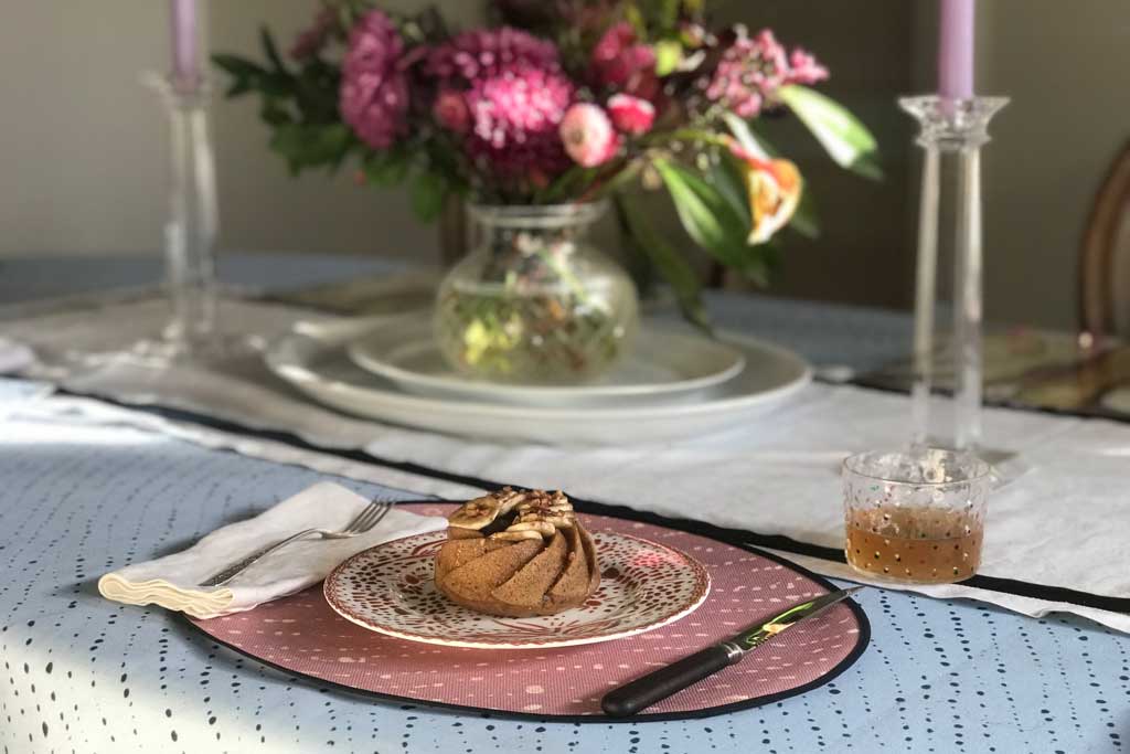 Sky staccato nero shibori tablecloth with dessert on mosaic garden plate on rose clay staccato decolorato shibori placemat