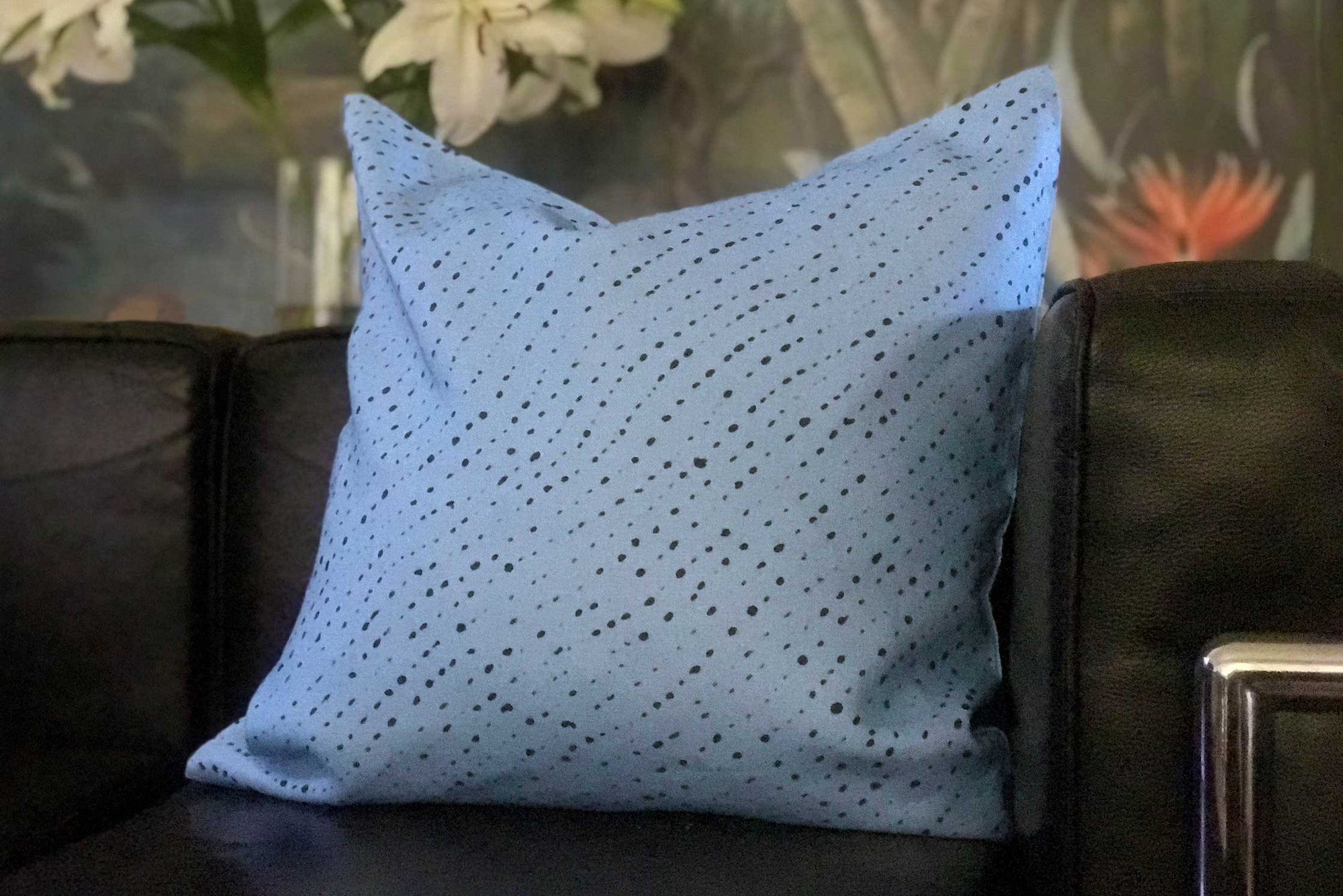 Venable Moore Staccato Nero Shibori Sky blue linen pillow on black sofa 