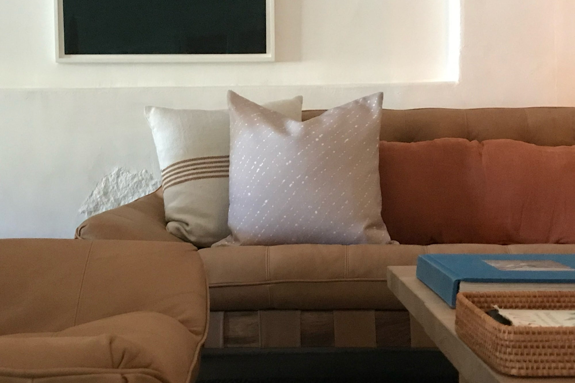 'Staccato Sbiancato' Shibori linen pillow in flax installed on sofa