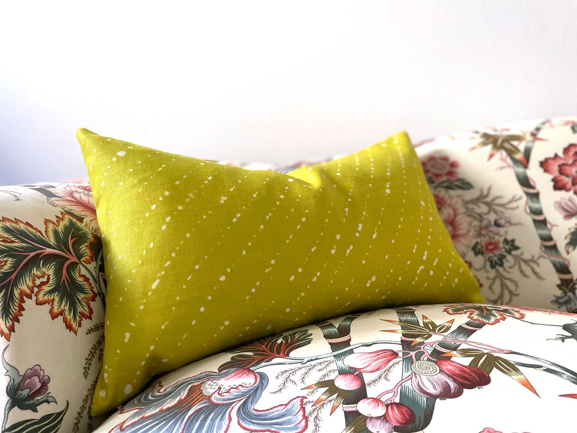 'Staccato Sbiancato' Shibori made to order 100% European Linen pillow in pear green on patterned sofa 