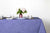 Staccato sbiancato shibori cotton tablecloth in cornflower on table with mosaic garden dinner plates and hand-painted confetti glasses and vase with roses