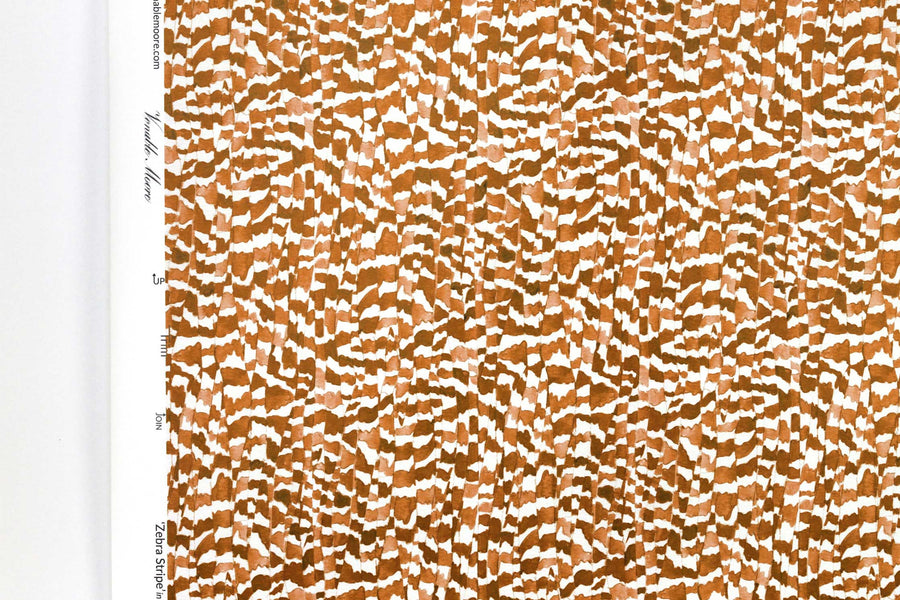 Up close view of Venable Moore Zebra Stripe abstract animal in chestnut brown FSC Certified Clay Coated wallpaper roll against a white wall