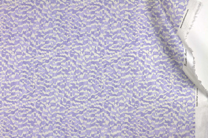 Venable Moore 100% European linen Zebra Stripe abstract animal fabric by the yard in lavender purple with top fold against white