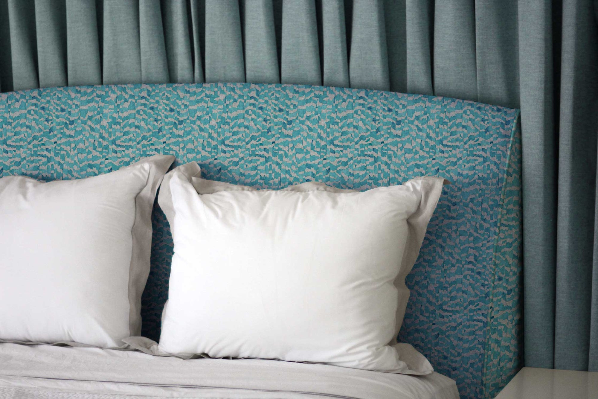 Zebra Stripe abstact animal linen in turquoise on an upholstered headboard bedroom install