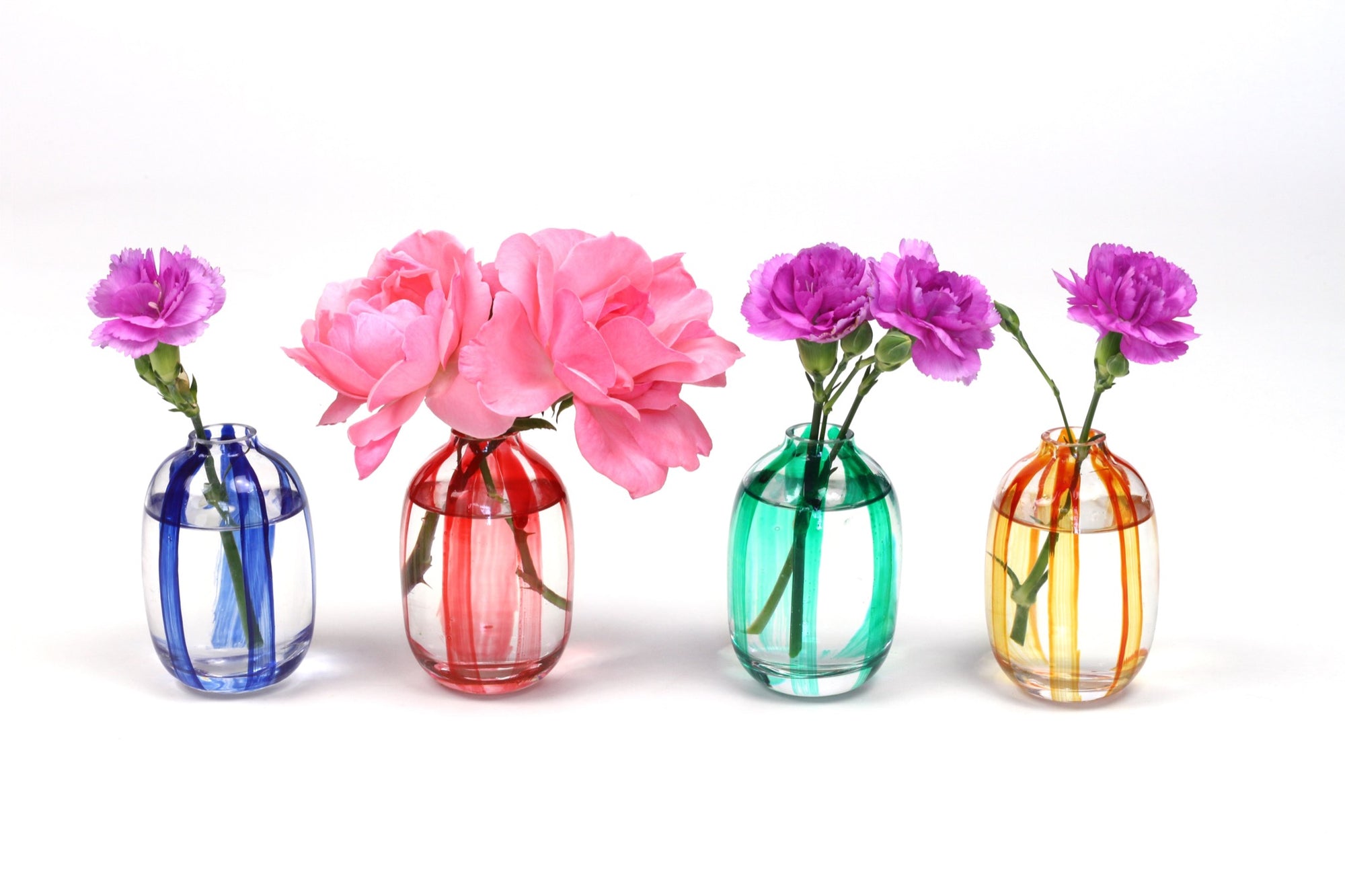 lapis blue hand-painted striped bud vase with carnation, tomato red hand-painted striped bud vase with pink roses, shamrock green hand-painted bud vase with carnation, tangerine orange hand-painted bud vase with carnation