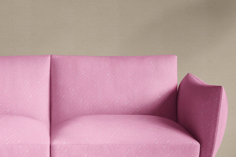 sofa upholstered in venable moore 100% european linen staccato sbiancato shibori fabric in fresh carnation pink made to order in the usa against grasscloth wall