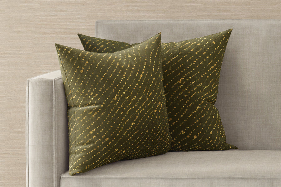 Two 20” x 20” 100% linen reversible staccato decolorato shibori pillows in fern green on a sofa