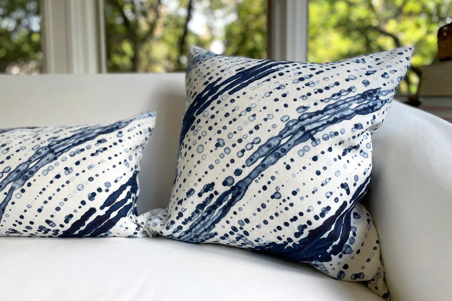 marine blue glissando shibori pillows in fine linen fabric by the yard on a white sofa