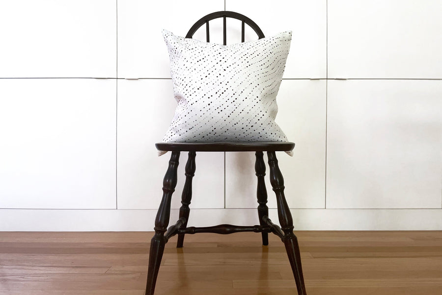 alabaster white staccato nero shibori pillow in fine linen fabric by the yard on a black windsor chair