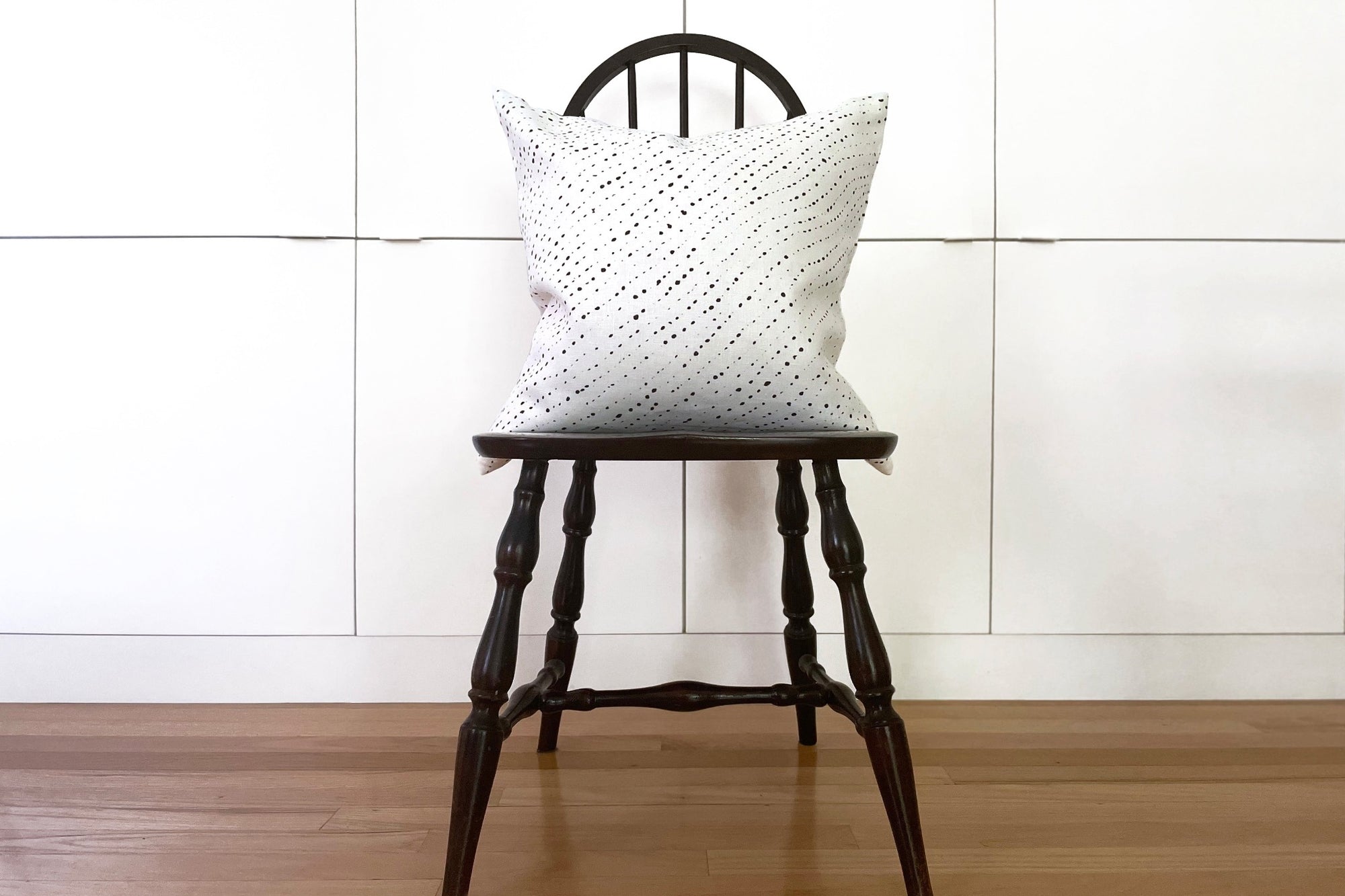 Venable Moore alabaster white staccato nero shibori pillow in fine linen fabric by the yard on a black windsor chair