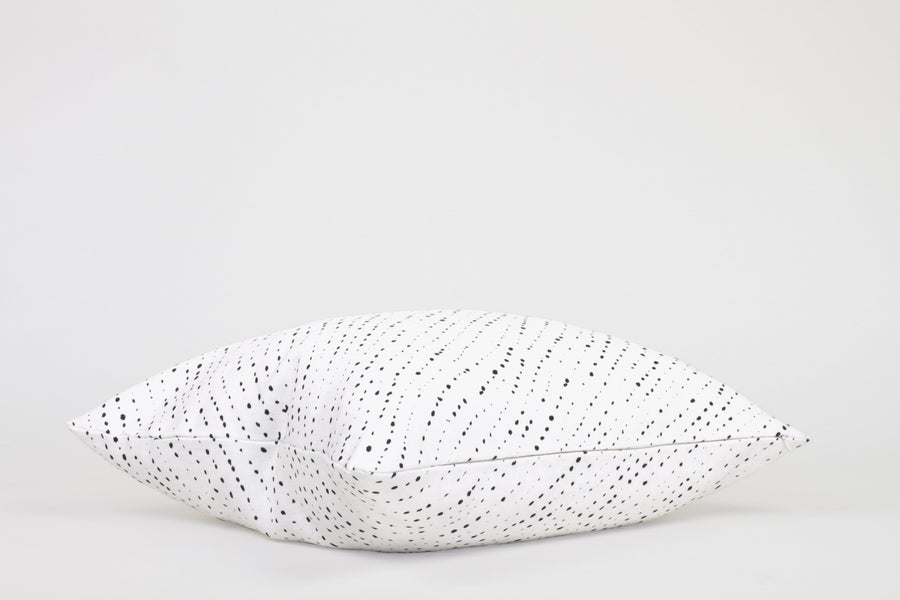 Side view 20” x 20” 100% linen staccato nero shibori pillow in alabaster white with hidden zipper
