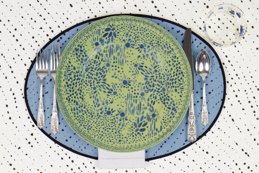 Venable Moore Mosaic Garden dinner plate in fresh apple green with hand-painted Bubble glass on sky blue 'Staccato Nero' Shibori linen placemat and alabaster white tablecloth with silverware and white linen napkin