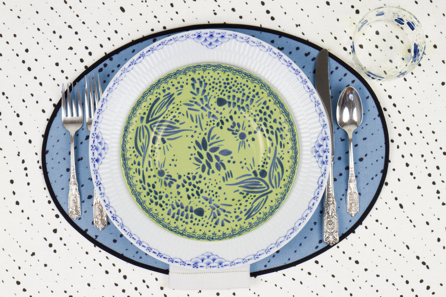 Venable Moore Mosaic Garden salad/dessert plate in fresh apple green on a blue and white plate with hand-painted Bubble glass on sky blue 'Staccato Nero' Shibori linen placemat and alabaster white tablecloth with silverware and white linen napkin