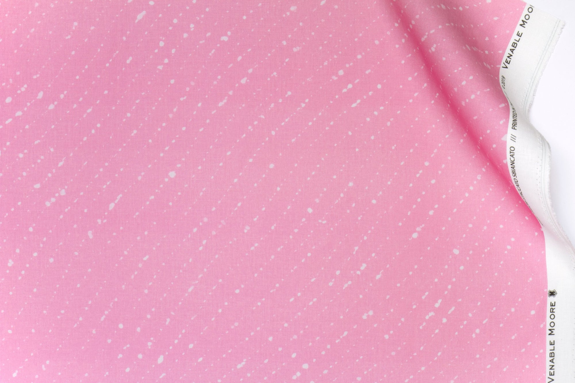 Venable moore 100% european linen staccato sbiancato shibori fabric by the yard in fresh carnation pink with top fold against white background