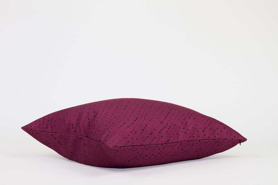 Side view 20” x 20” 100% linen staccato nero shibori pillow in cerise pink with hidden zipper