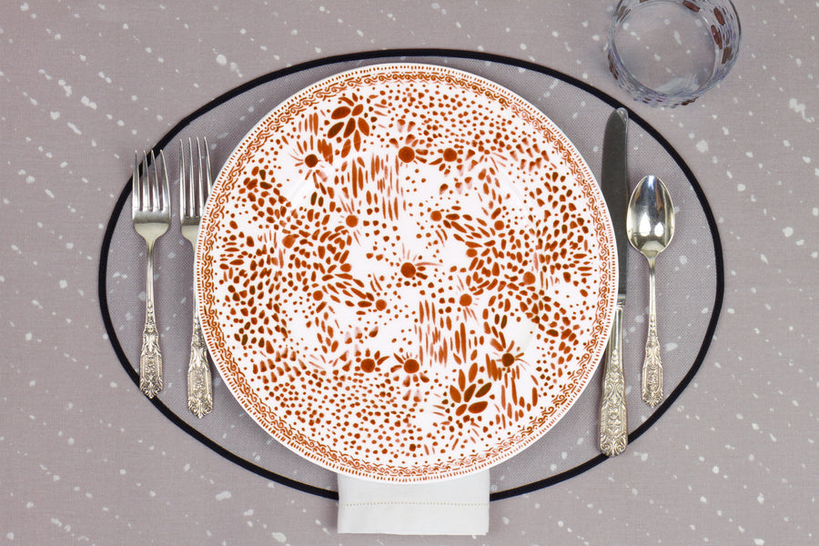 Venable Moore Mosaic Garden dinner plate in chestnut brown with hand-painted Bubble glass on neutral flax tan 'Staccato Sbiancato' Shibori linen placemat and tablecloth with silverware and white linen napkin