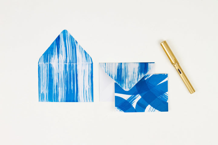 Hand-painted card and crimson line envelopes in cobalt blue in ‘stripes and squiggles’ pattern with gold pen