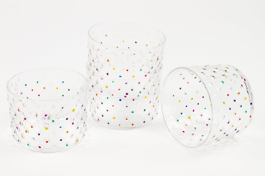 Set of four hand-painted confetti hobnail glasses stacked and scattered in multicolor dots