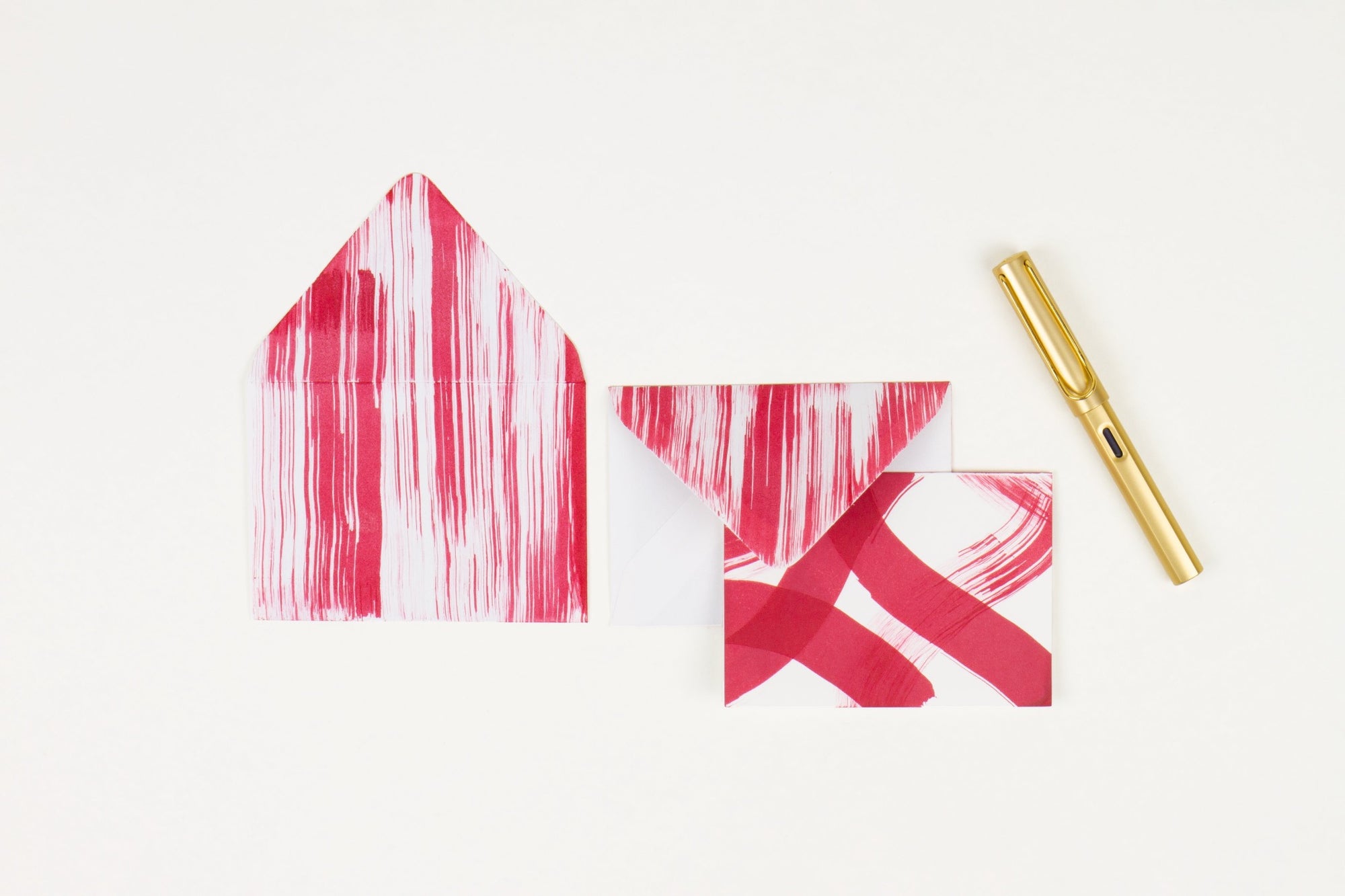 Hand-painted card and crimson lined envelopes in crimson red in ‘stripes and squiggles’ pattern with gold pen