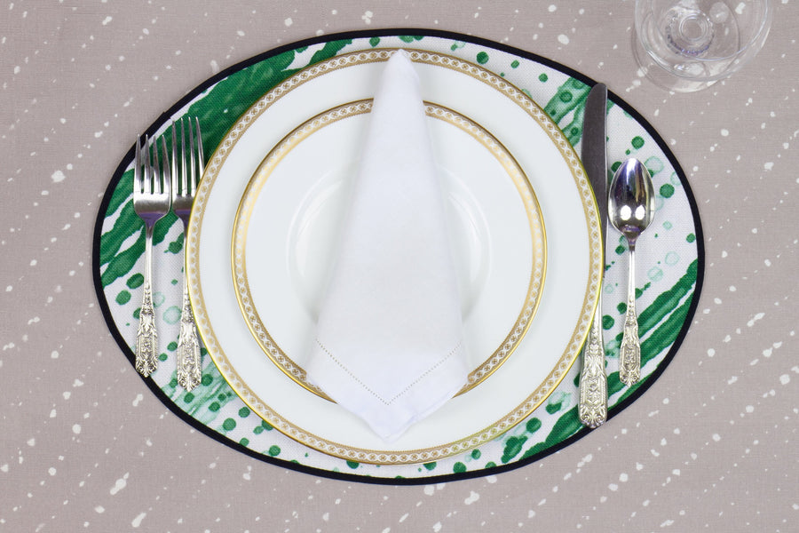 Place setting with 100% linen glissando shibori emerald green placemat on flax shibori linen with white plates