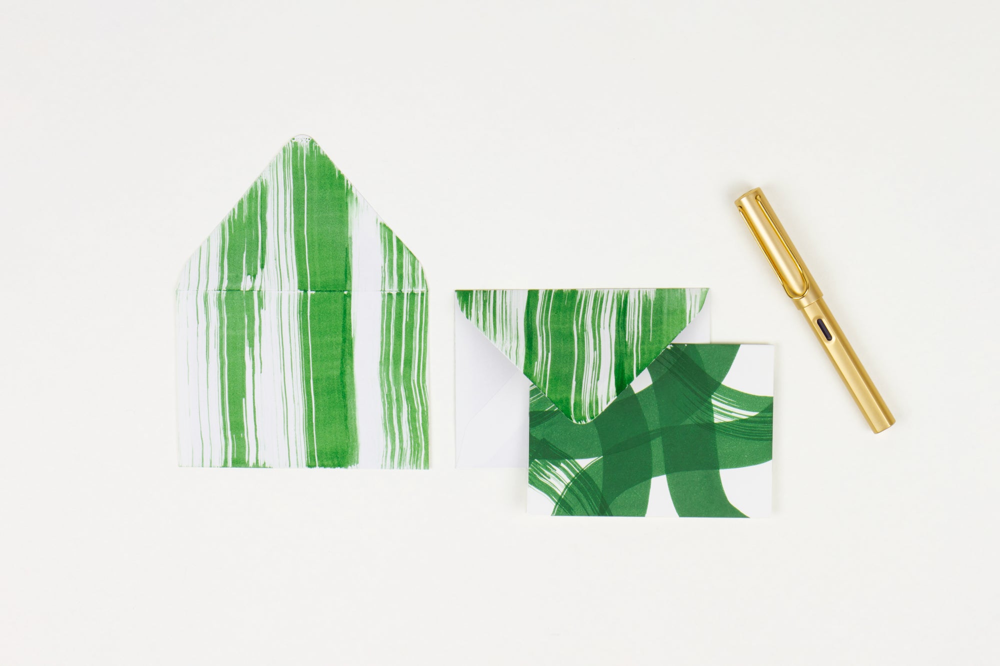 Hand-painted card and crimson lined envelopes in pine green in ‘stripes and squiggles’ pattern with gold pen